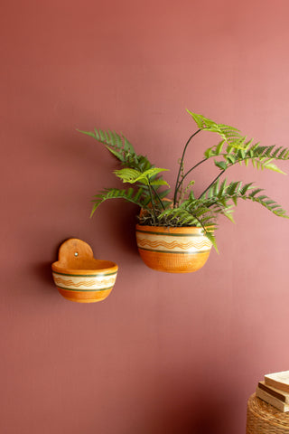 SET OF THREE PAINTED TERRACOTTA WALL PLANTERS