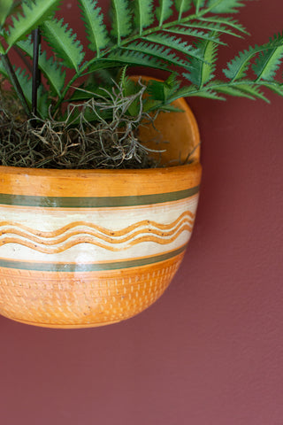 SET OF THREE PAINTED TERRACOTTA WALL PLANTERS