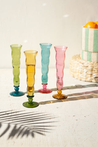 SET OF FOUR GLASS TRUMPET VESSELS - ONE EACH COLOR