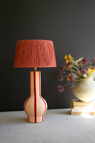 RED AND WHITE PAPER MACHE TABLE LAMP WITH RED RAFFIA SHADE