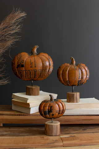 SET OF THREE RECYCLED METAL PUMPKINS ON WOODEN BASES