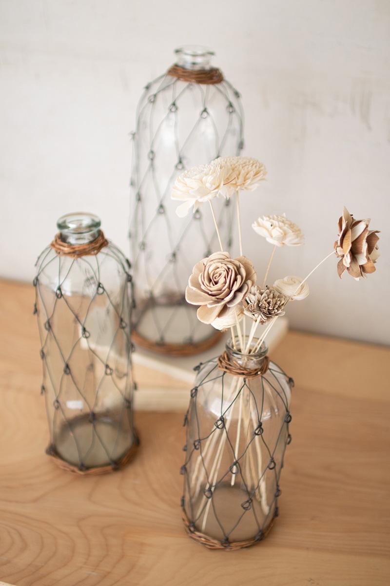 SET OF THREE TALL WIRE AND WICKER WRAPPED GLASS BOTTLES